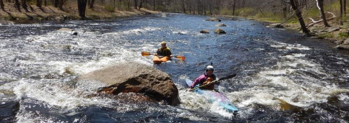 Whitewater kayakers running rapids